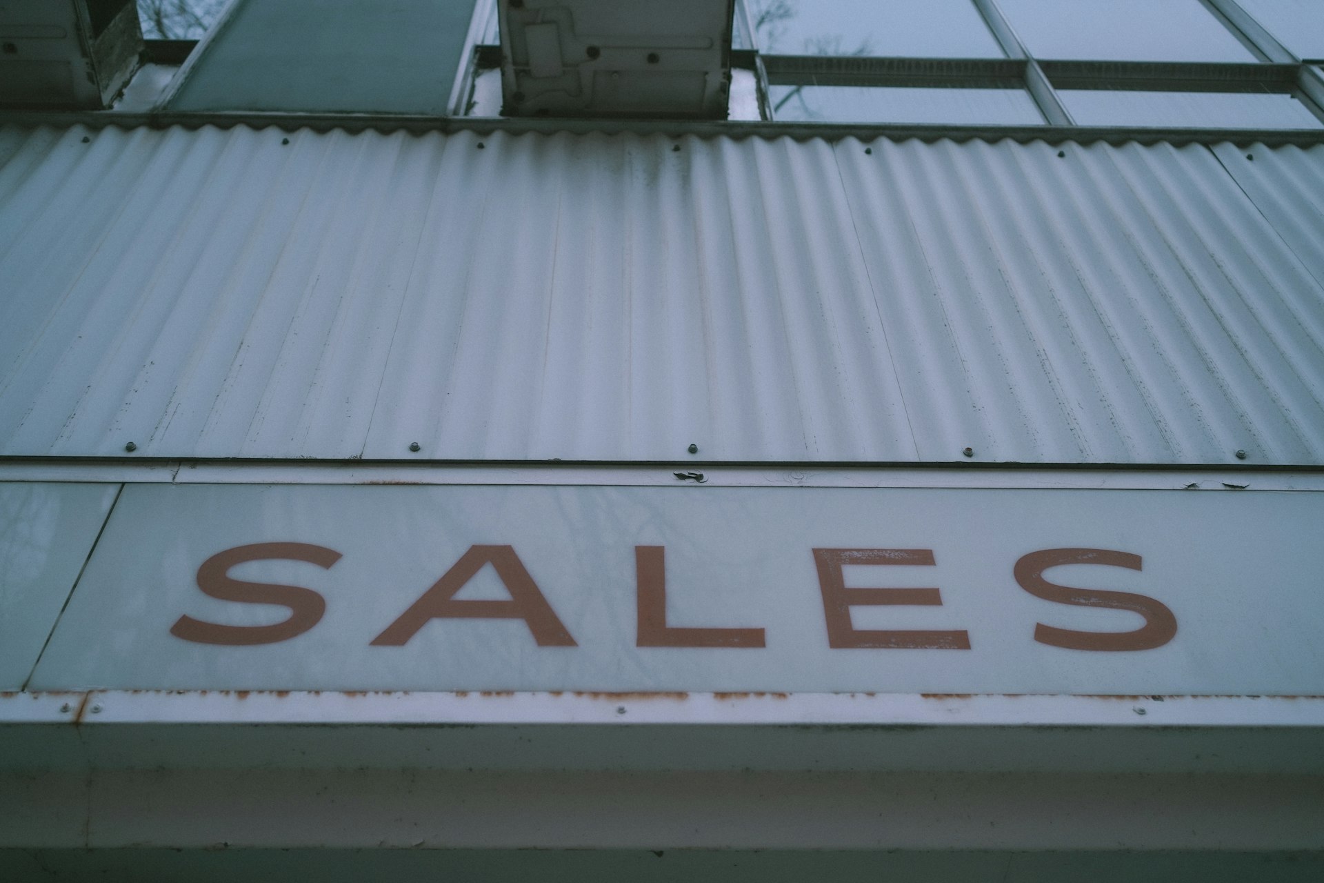 a sign that says sales on the side of a building
